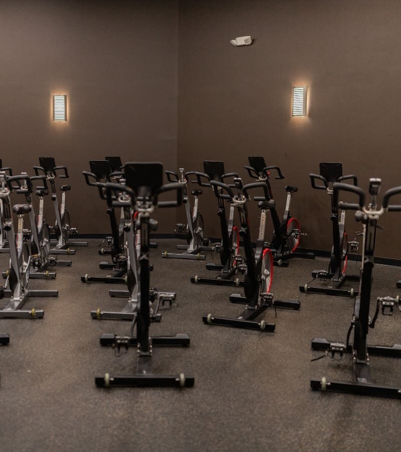 a spinning studio with cycling machines for group fitness at a queensgate gym